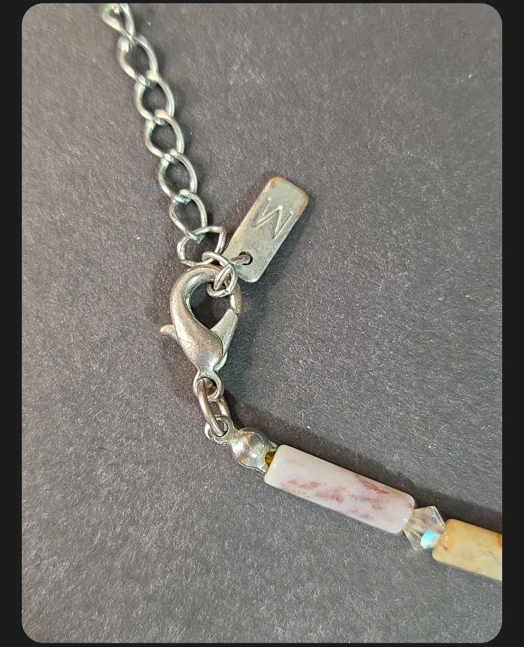 Oddly Darling Vintage artisan necklace featuring a silver lobster clasp, adjustable chain, and patterned stone beads.