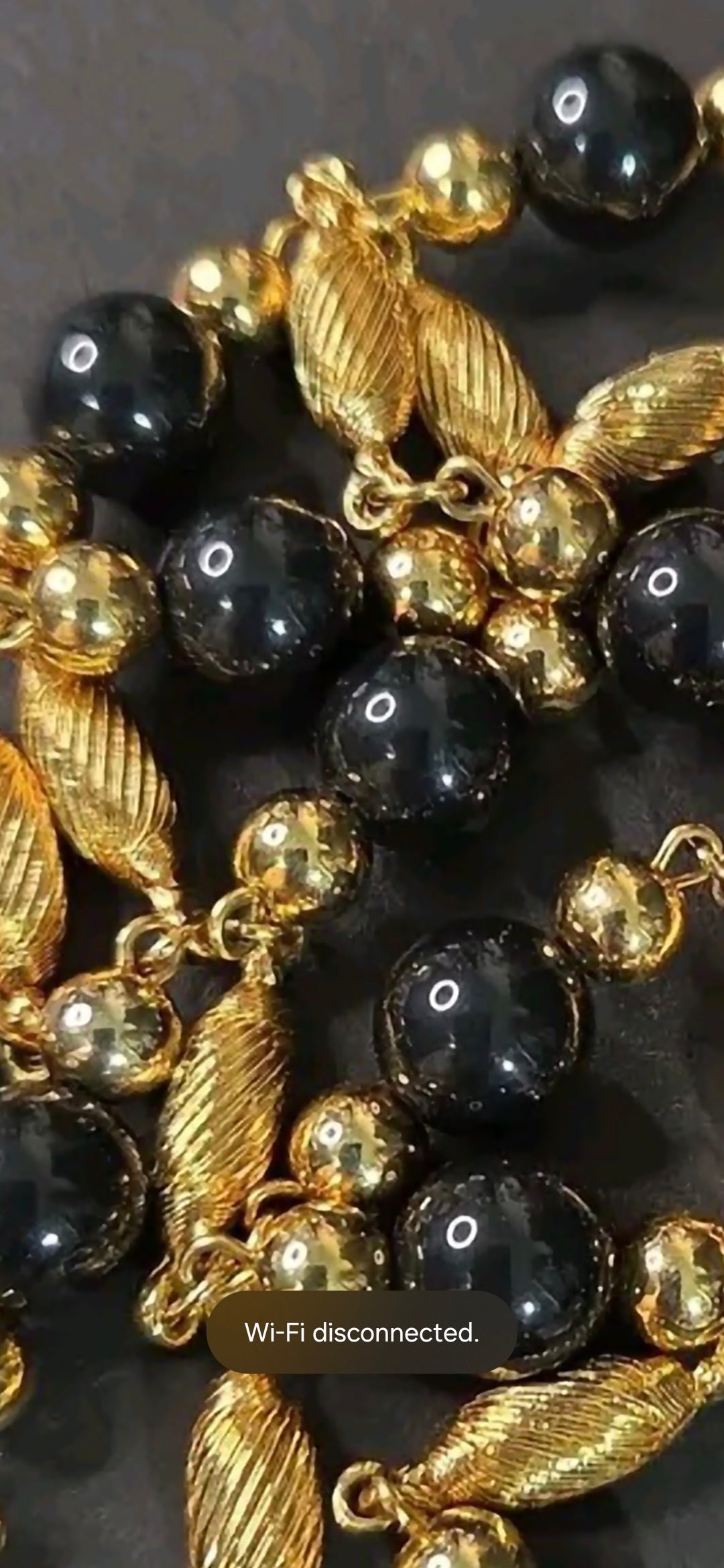 Oddly Darling Vintage long necklace featuring polished black beads and textured gold-tone metal spacers