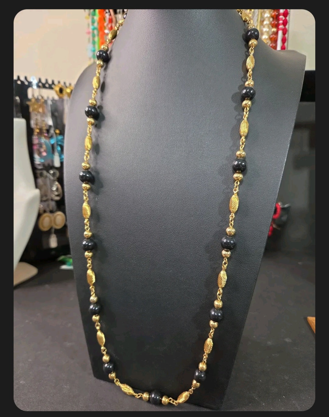 Oddly Darling Vintage long necklace featuring alternating polished black beads and textured gold-tone metal spacers.