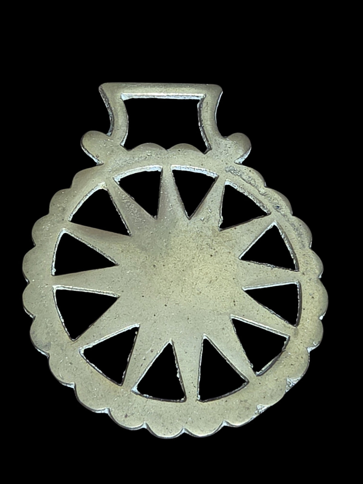Oddly Darling Vintage brass horse harness medallion featuring a sunburst design and scalloped edge on black background