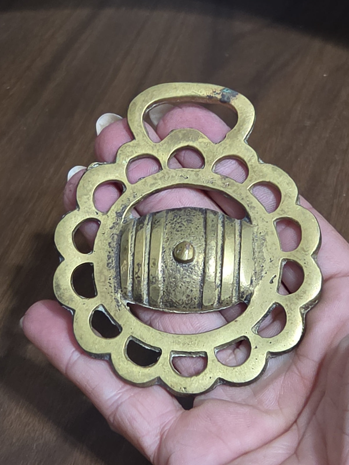 Oddly Darling Vintage brass horse harness medallion featuring a scalloped circular frame and central barrel motif.
