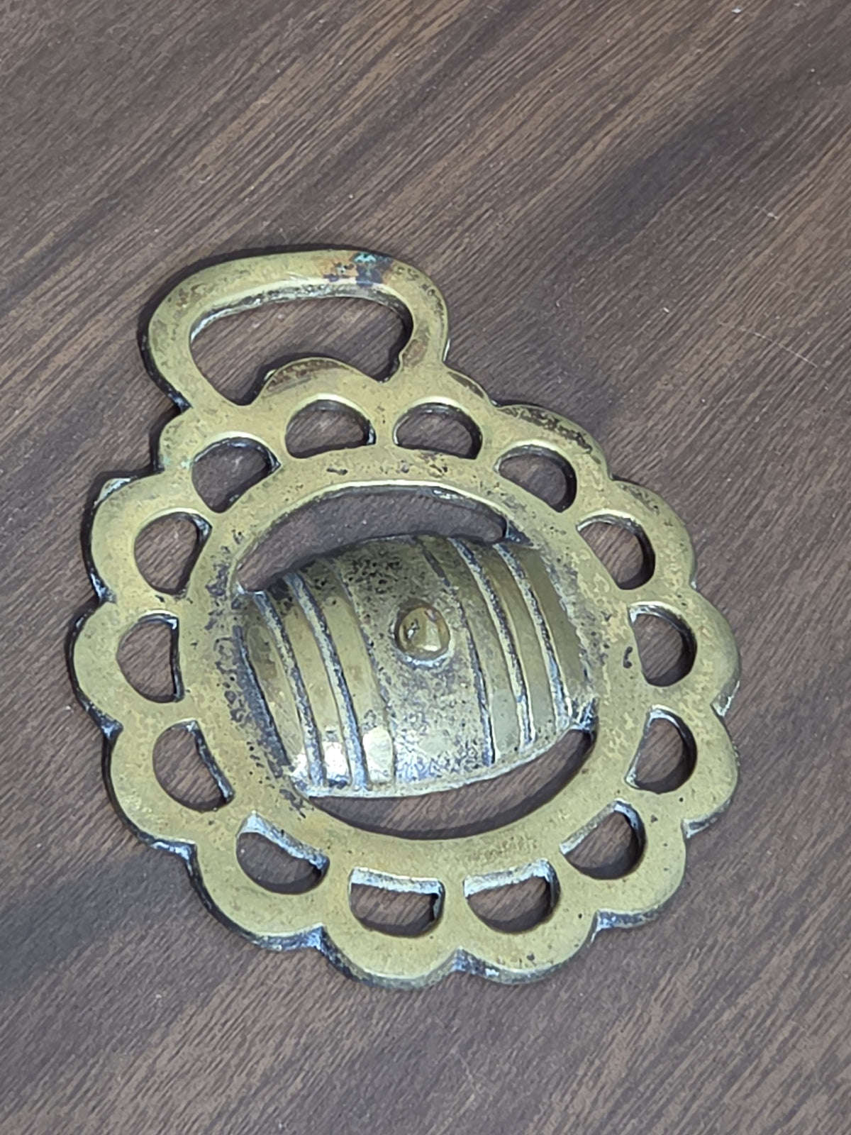 Oddly Darling Vintage brass horse harness medallion with a scalloped circular frame and central barrel motif.