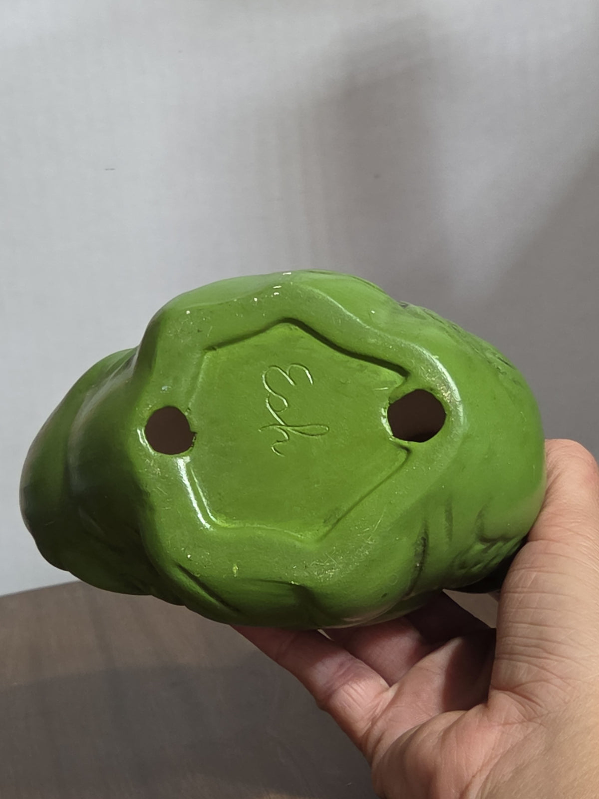 Oddly Darling Vintage ceramic duck figurine base showing the maker's mark and two drainage holes in matte green glaze