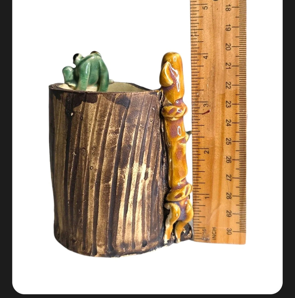 Oddly Darling Vintage handcrafted ceramic tree stump vessel with a green frog and bamboo accent next to a ruler.