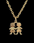 Oddly Darling Vintage gold-tone necklace featuring a pendant of two children holding hands with textured detailing.