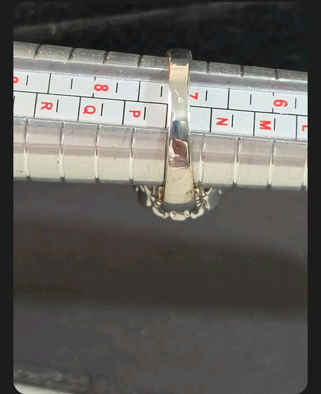 Oddly Darling Vintage silver-tone cocktail ring on a metal ring sizer measuring approximately size P.