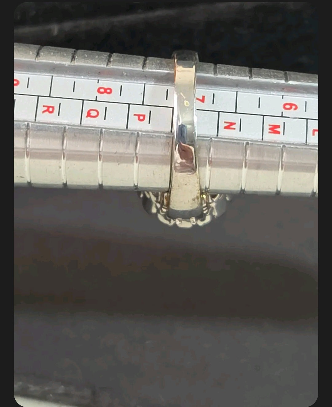 Oddly Darling Vintage silver-tone cocktail ring on a metal ring sizer measuring approximately size P.