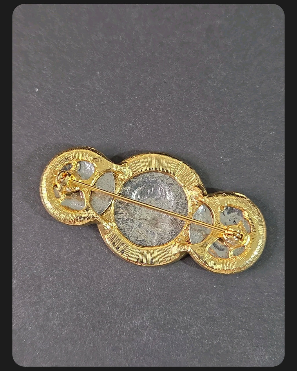 Back view of Oddly Darling Vintage coin brooch featuring a gold-tone setting with a secure pin closure.