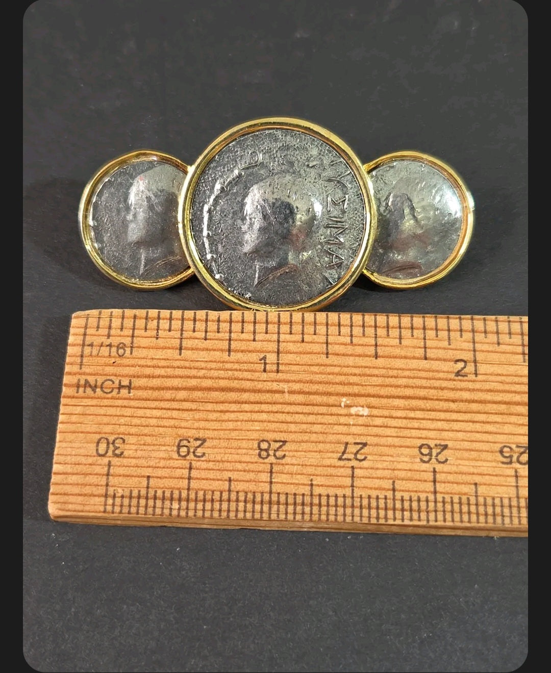 Oddly Darling Vintage brooch featuring three antique silver coin medallions in polished gold-tone settings with ruler
