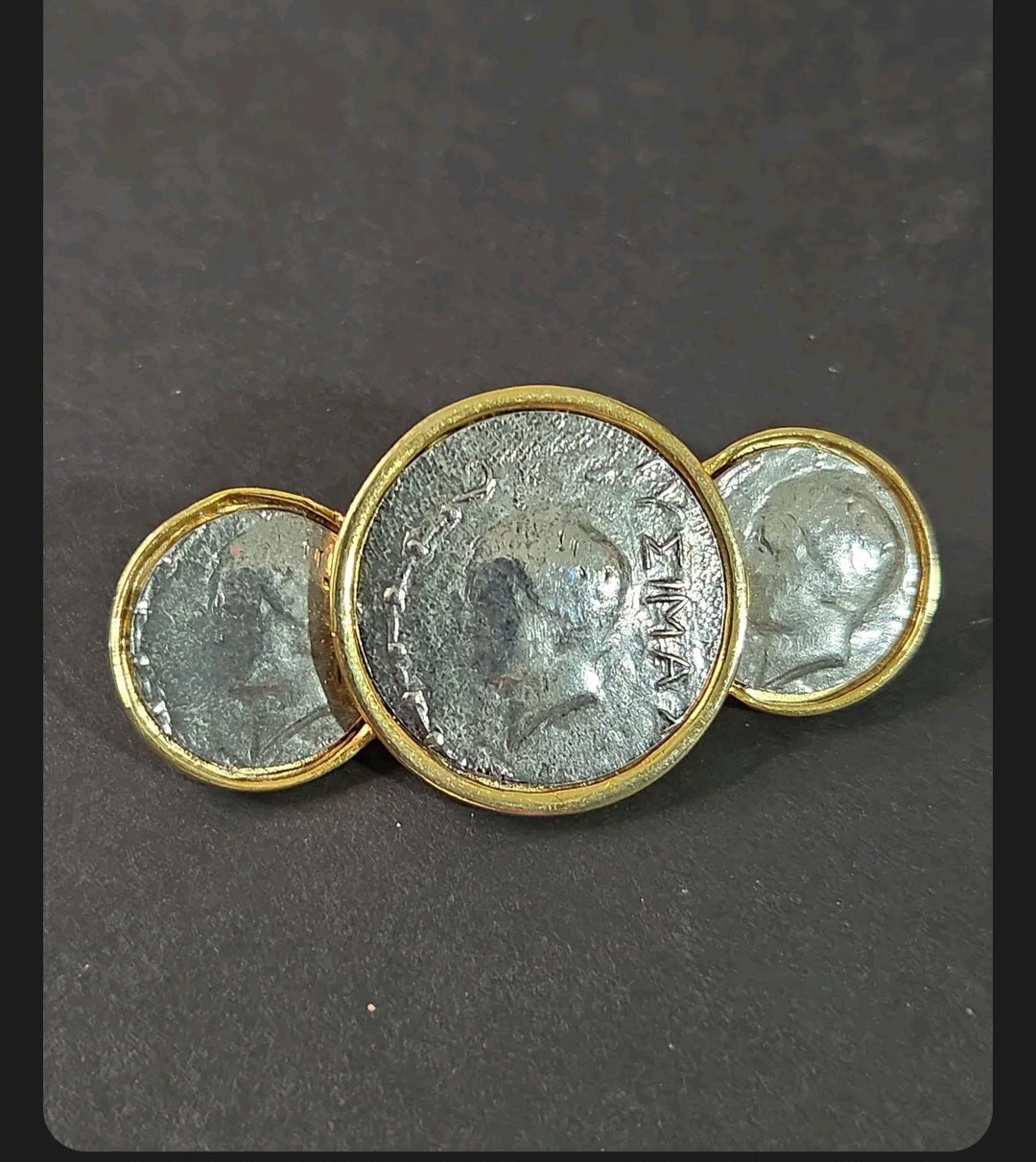 Oddly Darling Vintage statement brooch featuring three antique silver coin medallions in polished gold-tone settings.