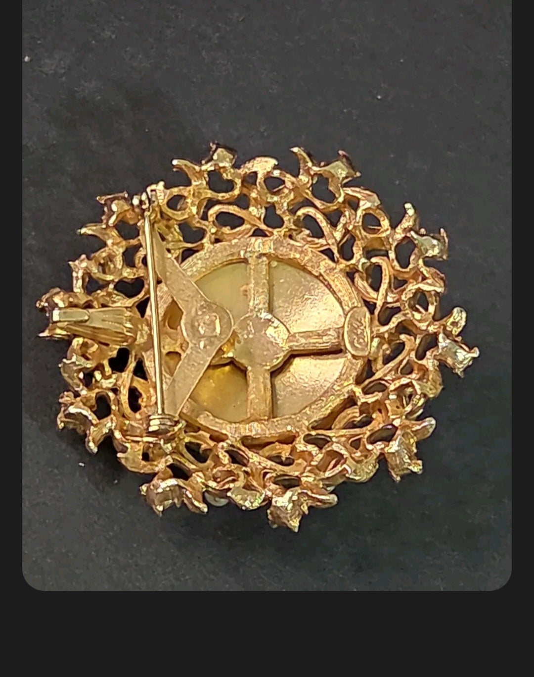Oddly Darling Vintage Coro brooch back view showing the gold-tone metal open-work setting and secure pin-back closure.