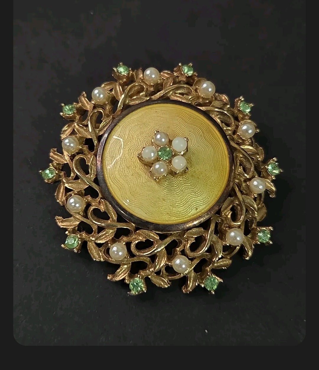 Oddly Darling Vintage Coro brooch featuring a gold guilloché enamel disc, faux pearls, and green rhinestones.