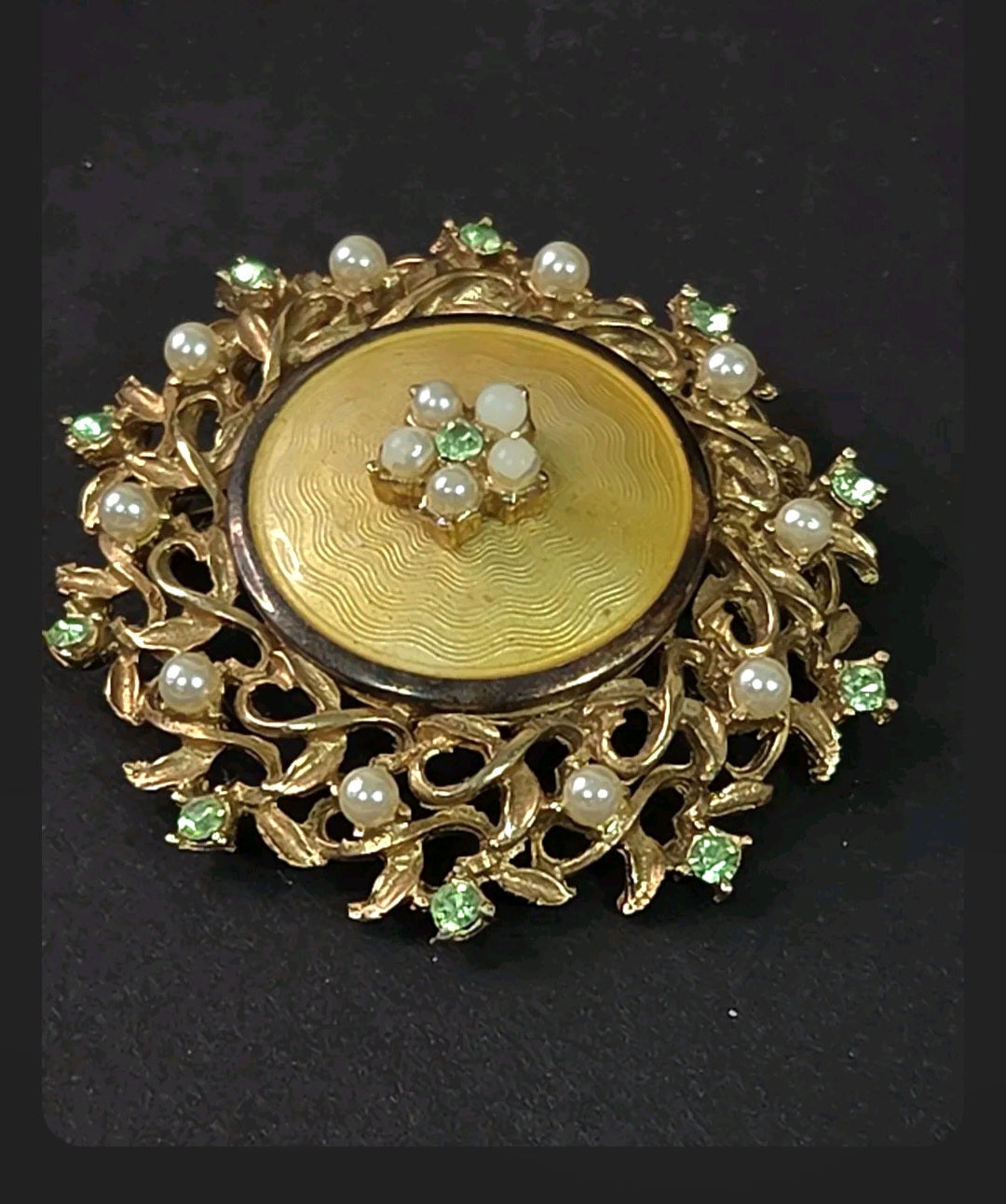 Oddly Darling Vintage Coro brooch with gold guilloché enamel, faux pearls, and green rhinestones in a floral design.