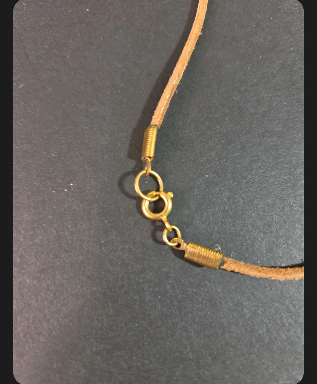 Oddly Darling Vintage crayon necklace featuring a natural leather cord and gold-tone metal spring clasp hardware.