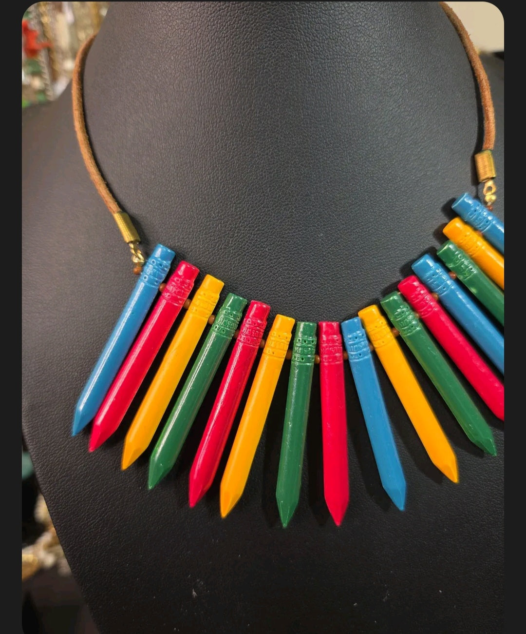 Oddly Darling Vintage crayon statement necklace with colorful pendants on a brown leather cord and gold-tone hardware.