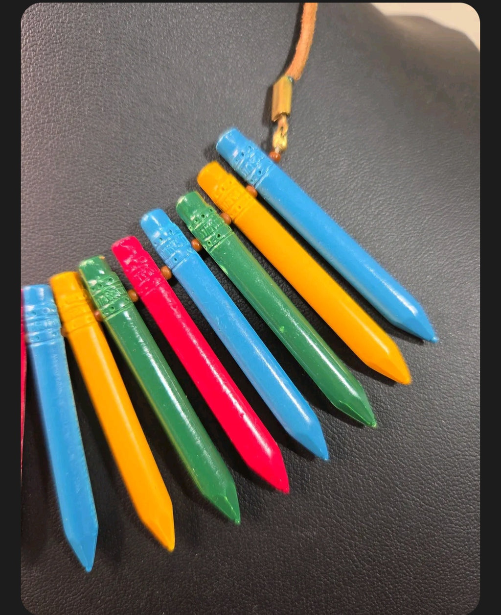 Oddly Darling Vintage colorful crayon statement necklace with a natural leather cord and gold-tone hardware.