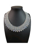 Oddly Darling Vintage handcrafted crystal statement collar necklace with multi-layered faceted clear beads on a display