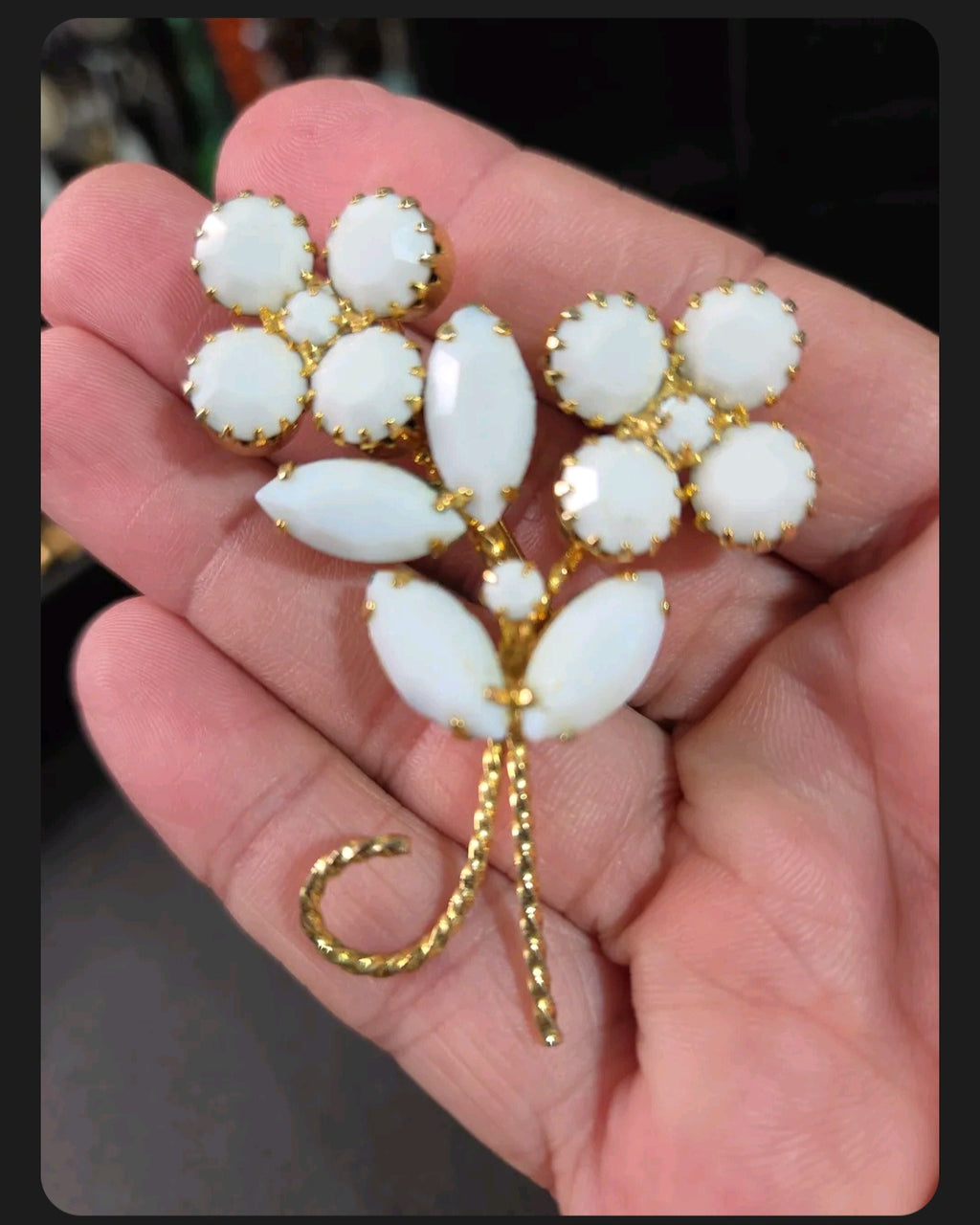 Oddly Darling Vintage floral brooch featuring white cabochon stones and marquise leaves in a gold-tone setting.