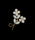 Oddly Darling Vintage floral brooch featuring white cabochon flower clusters and gold-tone marquise leaves.