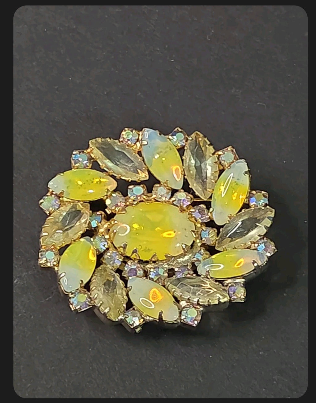 Oddly Darling Vintage floral brooch with a central oval cabochon, marquise-cut iridescent stones, and gold-tone base.