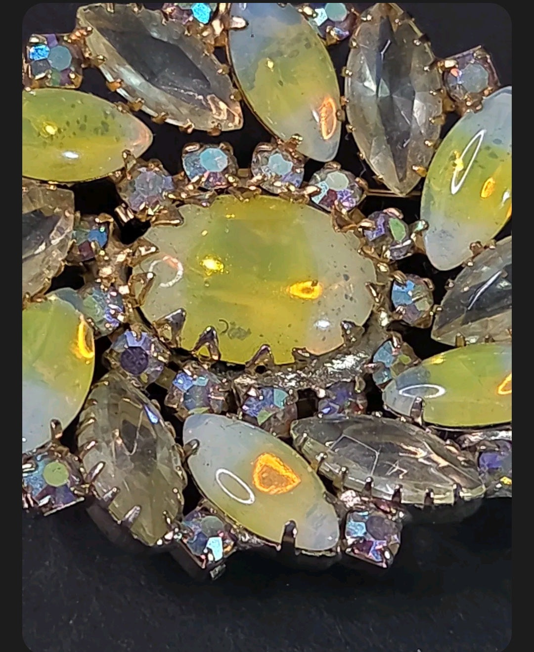 Oddly Darling Vintage floral brooch with iridescent oval cabochon and marquise-cut rhinestones in gold-tone setting.