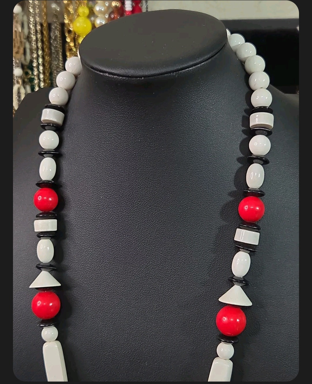 Oddly Darling Vintage geometric statement necklace featuring red, white, and black beads in various architectural shapes.
