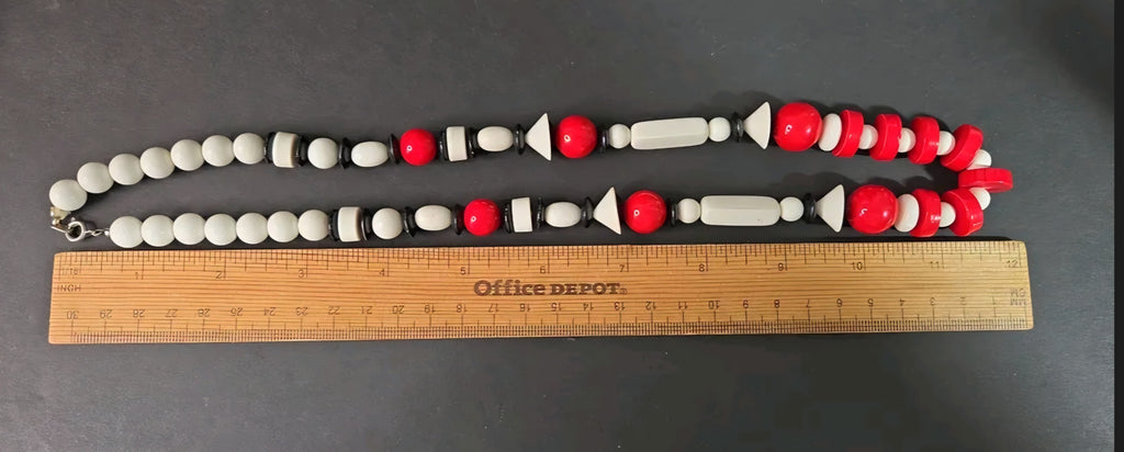 Oddly Darling Vintage geometric statement necklace featuring red, white, and black beads in various architectural shapes.