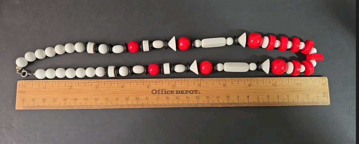 Oddly Darling Vintage geometric statement necklace featuring red, white, and black beads in various architectural shapes.