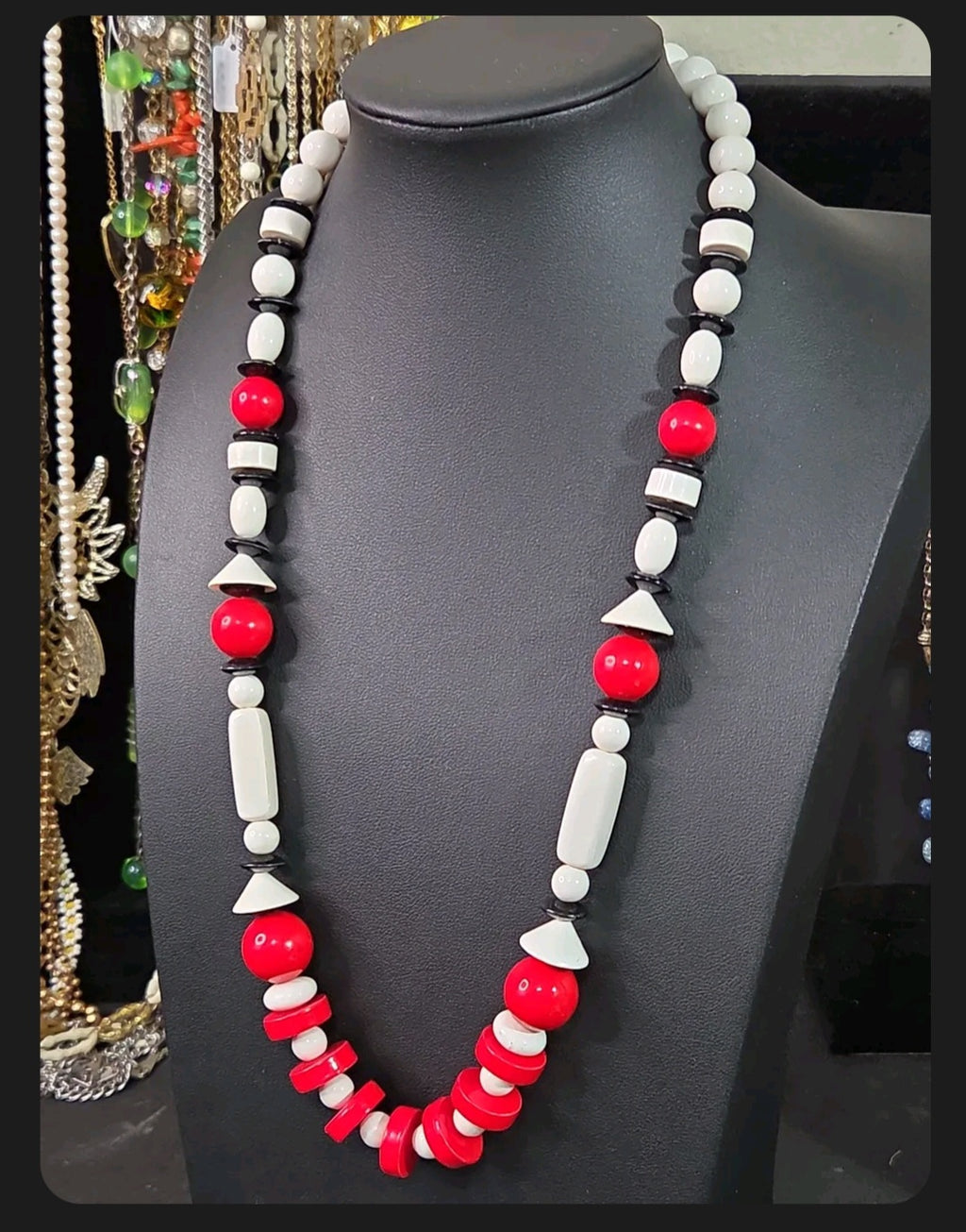 Oddly Darling Vintage geometric statement necklace featuring red, white, and black beads in various shapes on a bust.