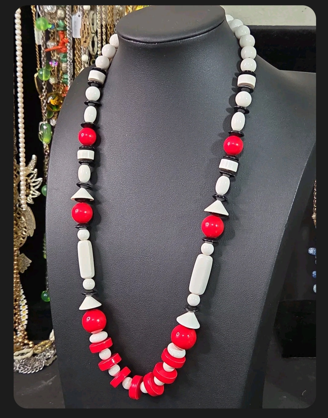 Oddly Darling Vintage geometric statement necklace featuring red, white, and black beads in various shapes on a bust.