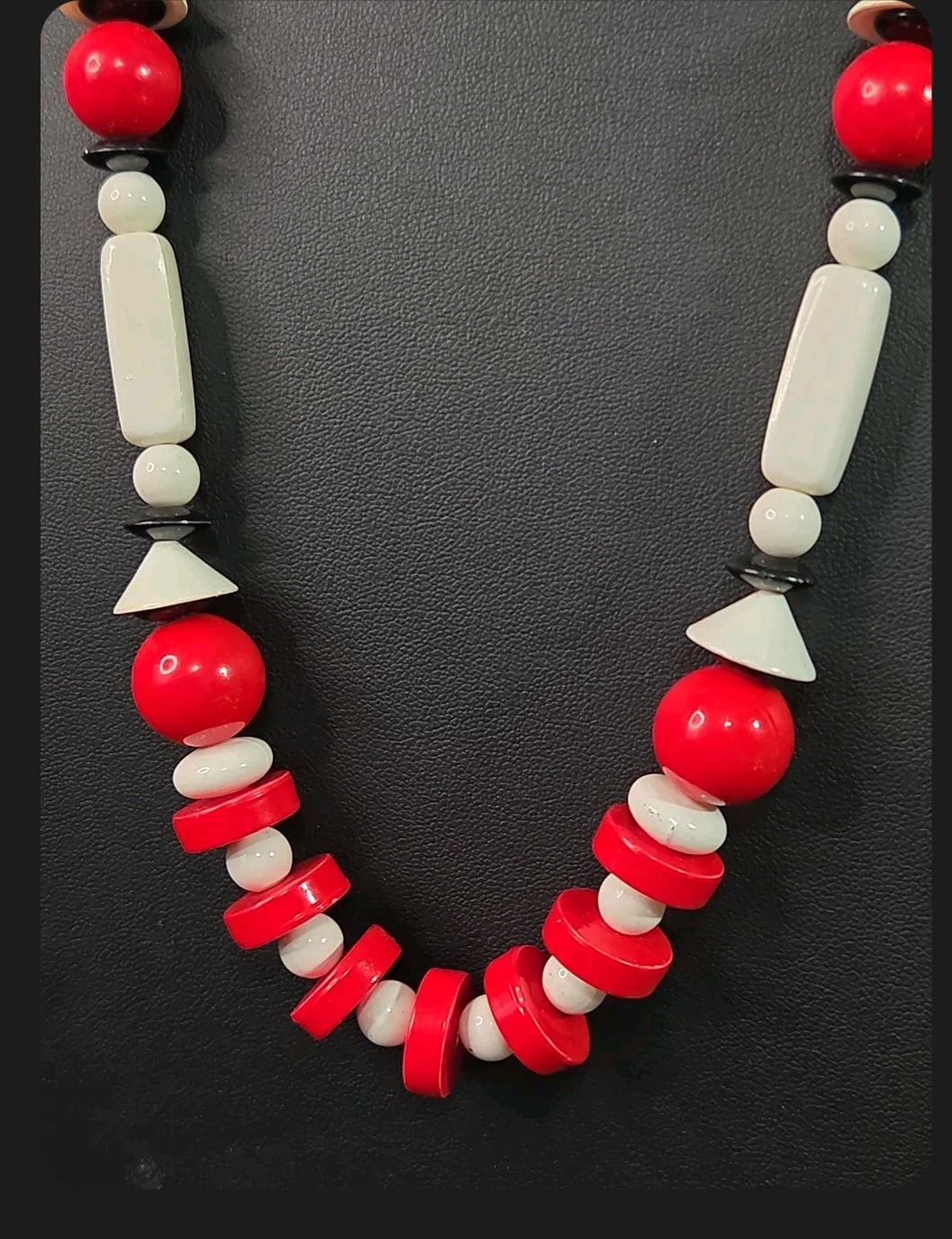 Oddly Darling Vintage geometric statement necklace featuring red, white, and black beads in sphere and disc shapes.