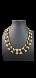 Oddly Darling Vintage geometric collar necklace featuring navy blue and cream enamel tiles with gold-tone metal accents.