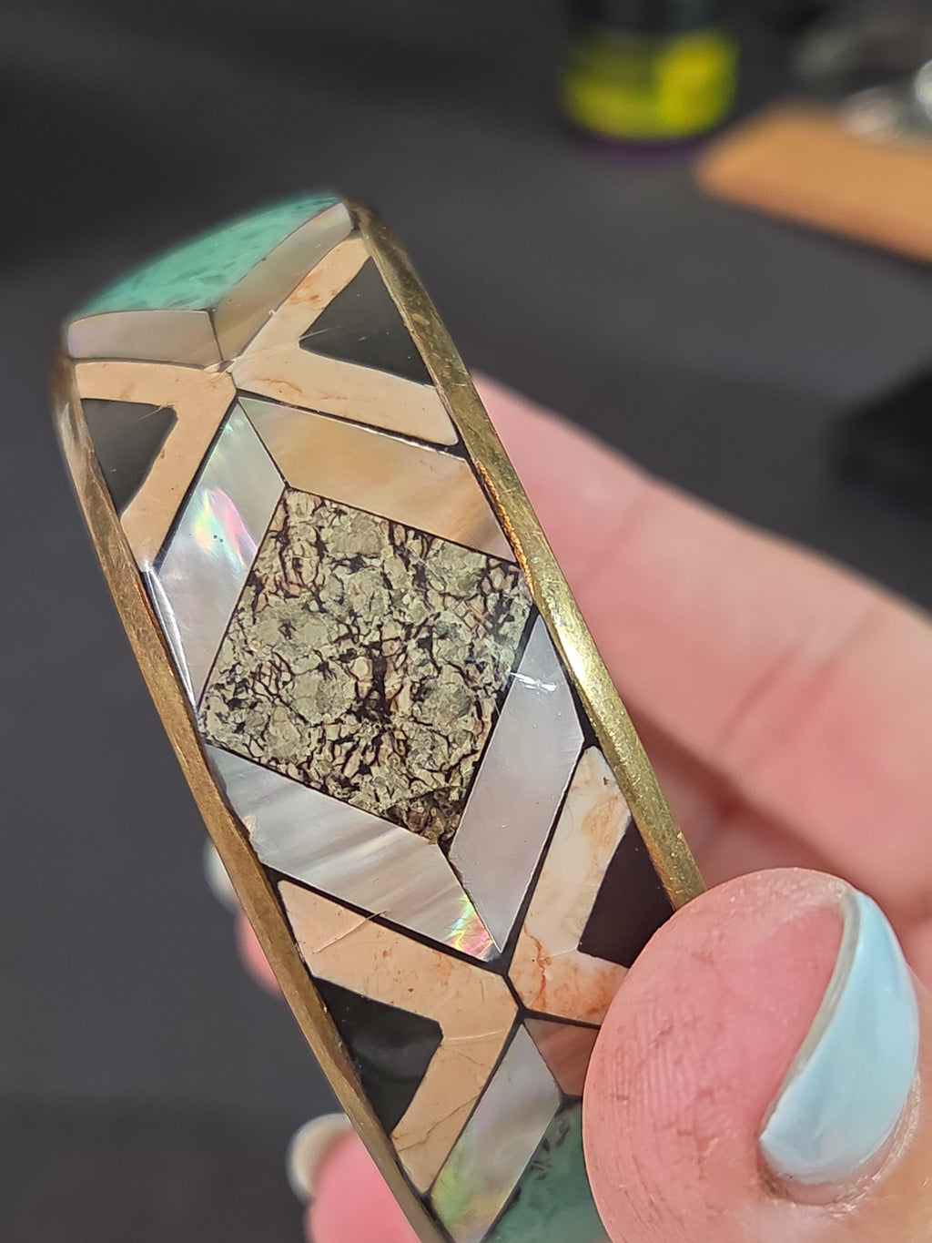 Oddly Darling Vintage geometric bangle with mother-of-pearl, stone, and turquoise inlay in a gold-tone metal frame.