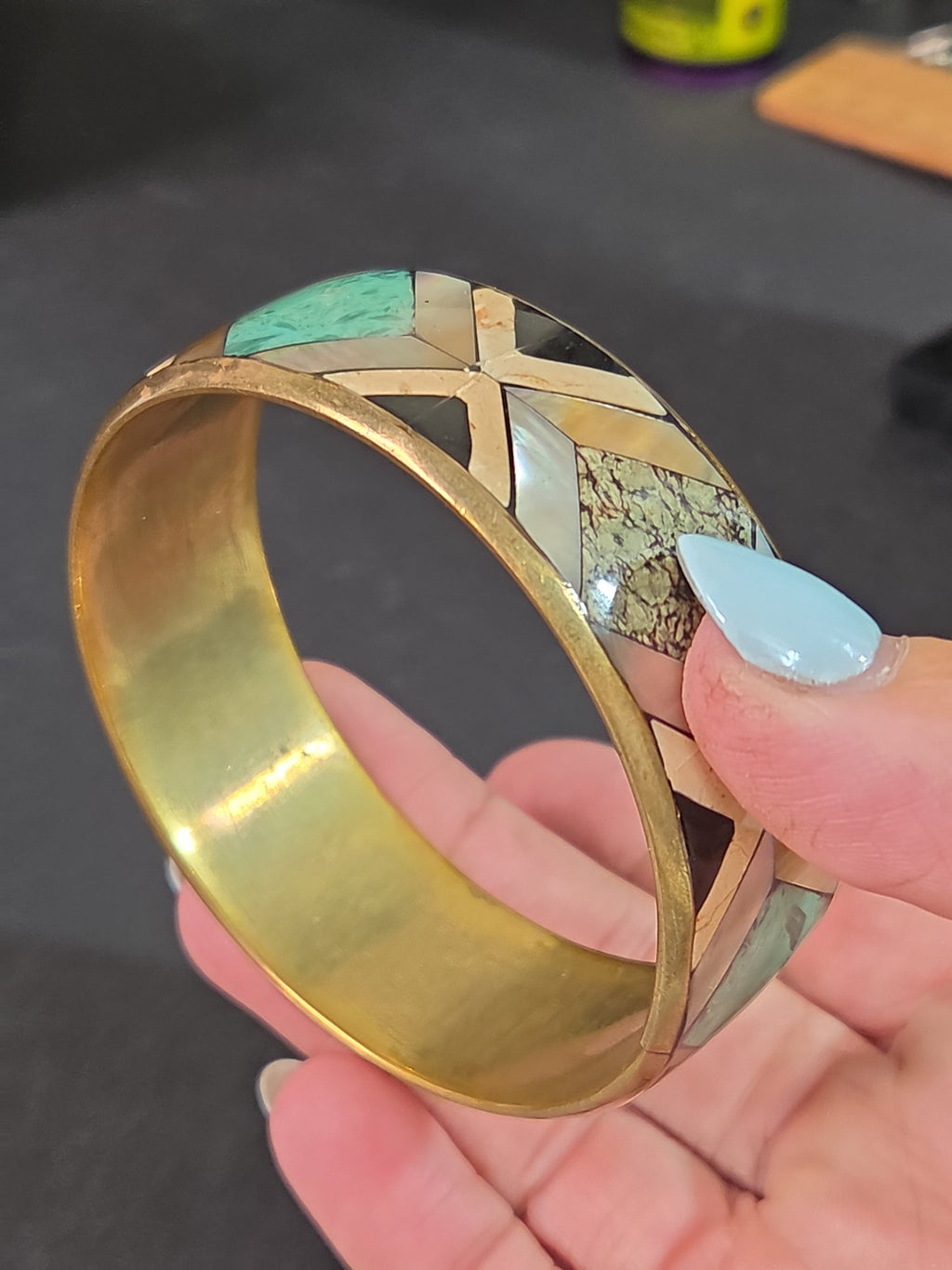 Oddly Darling Vintage geometric bangle with mother-of-pearl, stone, and turquoise inlay in a gold-tone metal frame.