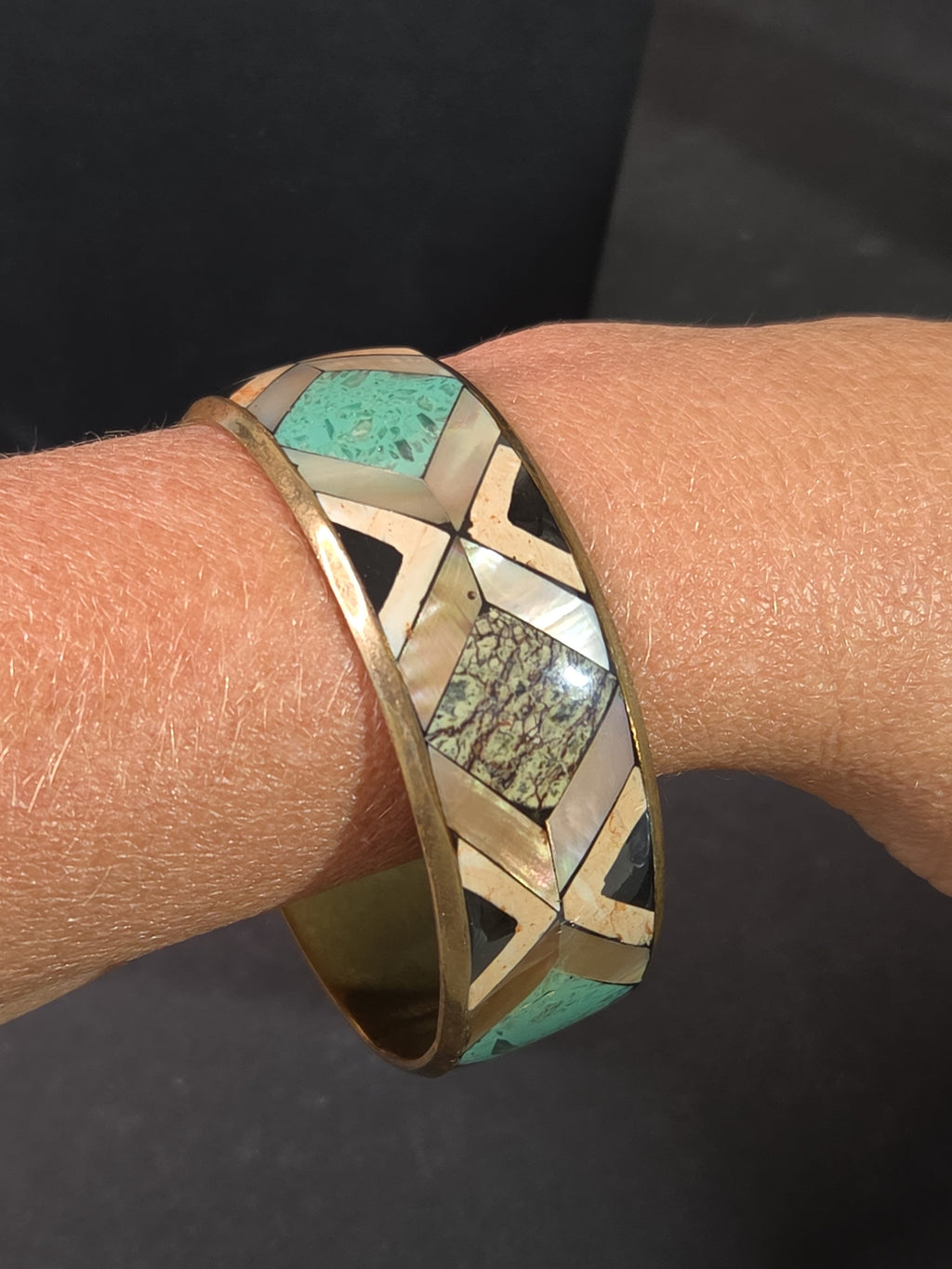 Oddly Darling Vintage geometric bangle with mother-of-pearl, turquoise, and stone inlay in a gold-tone metal frame.