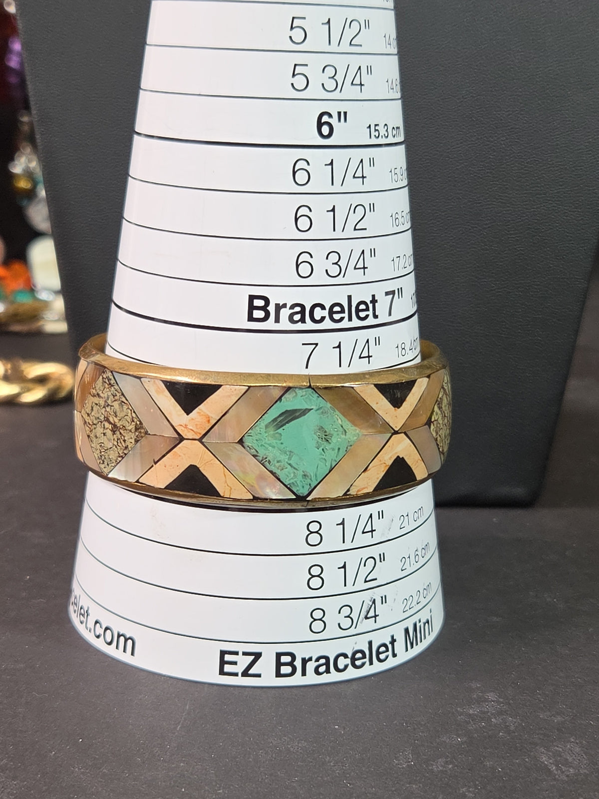 Oddly Darling Vintage geometric bangle with mother-of-pearl, stone, and turquoise inlay on a gold-tone metal frame.