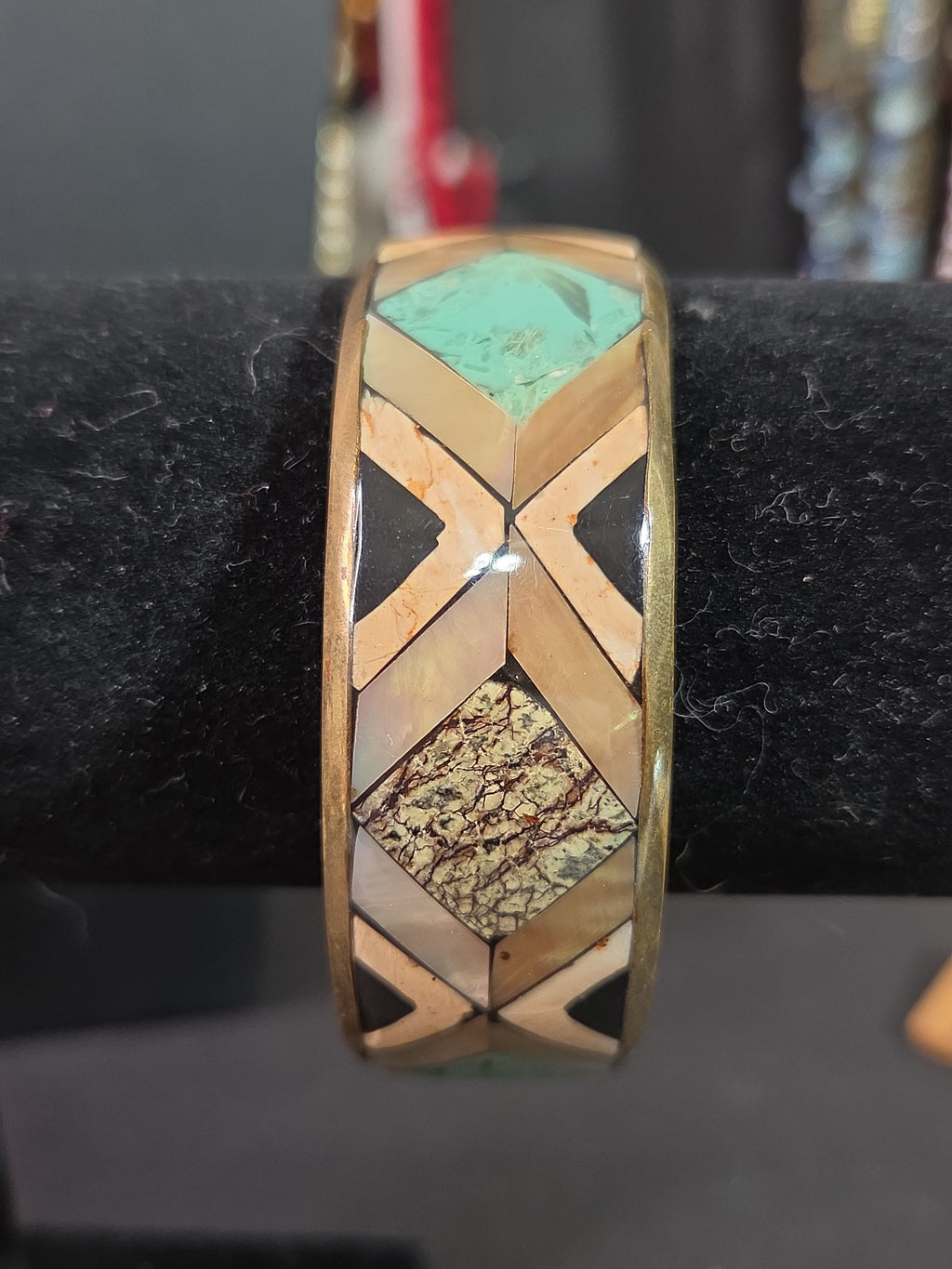 Oddly Darling Vintage geometric bangle with mother-of-pearl, turquoise, and stone inlay in a gold-tone metal frame.