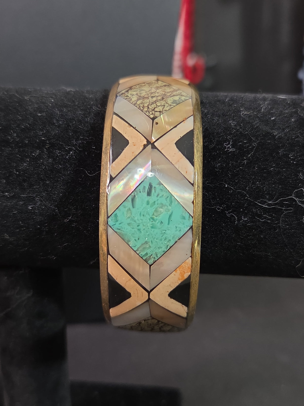 Oddly Darling Vintage geometric bangle with mother-of-pearl, turquoise, and stone inlay in a gold-tone metal frame.