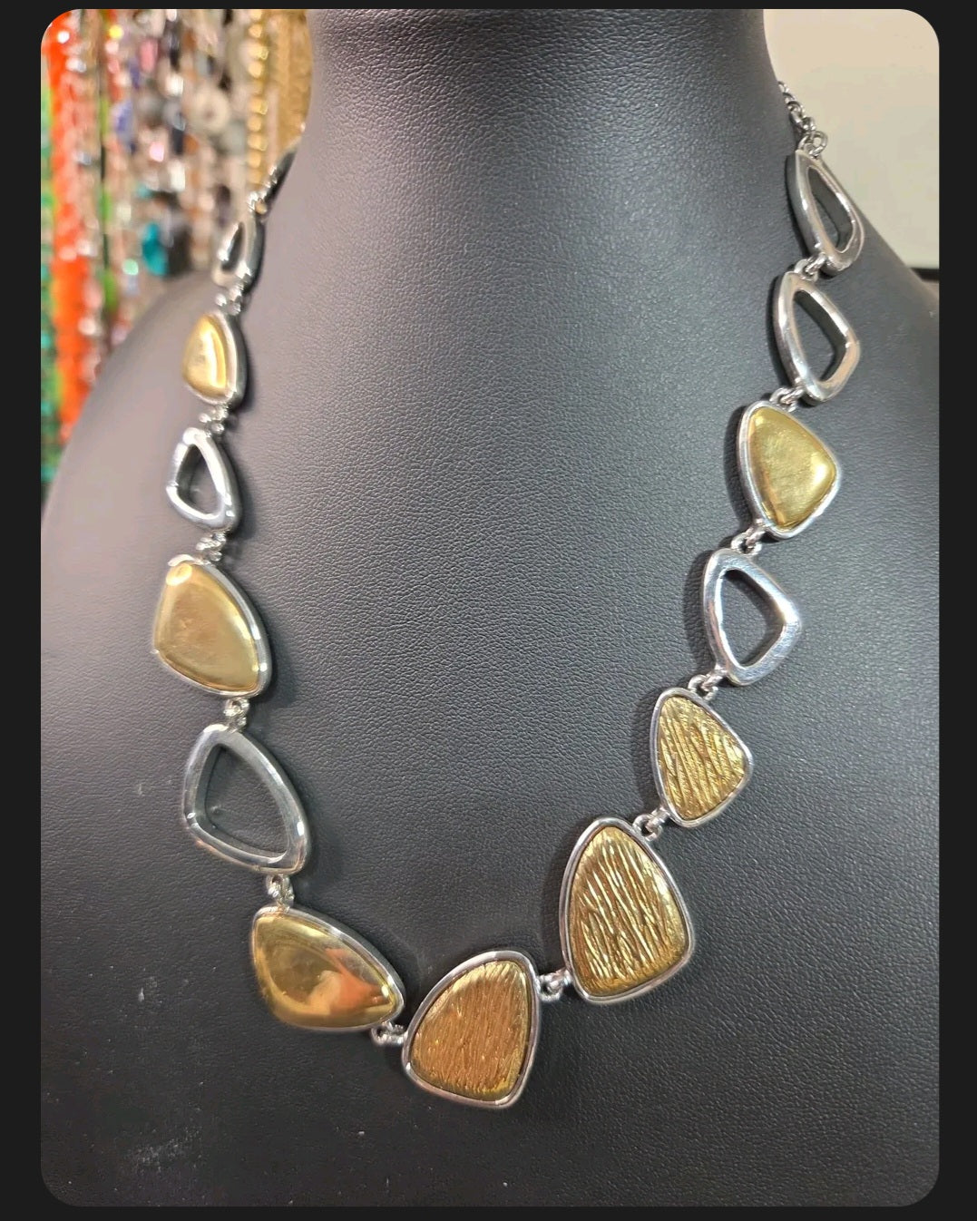 Oddly Darling Vintage mixed-metal statement necklace with alternating silver and gold geometric links on a display bust.