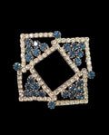 Oddly Darling Vintage geometric brooch featuring clear crystals and blue stones in a square-within-a-square design.
