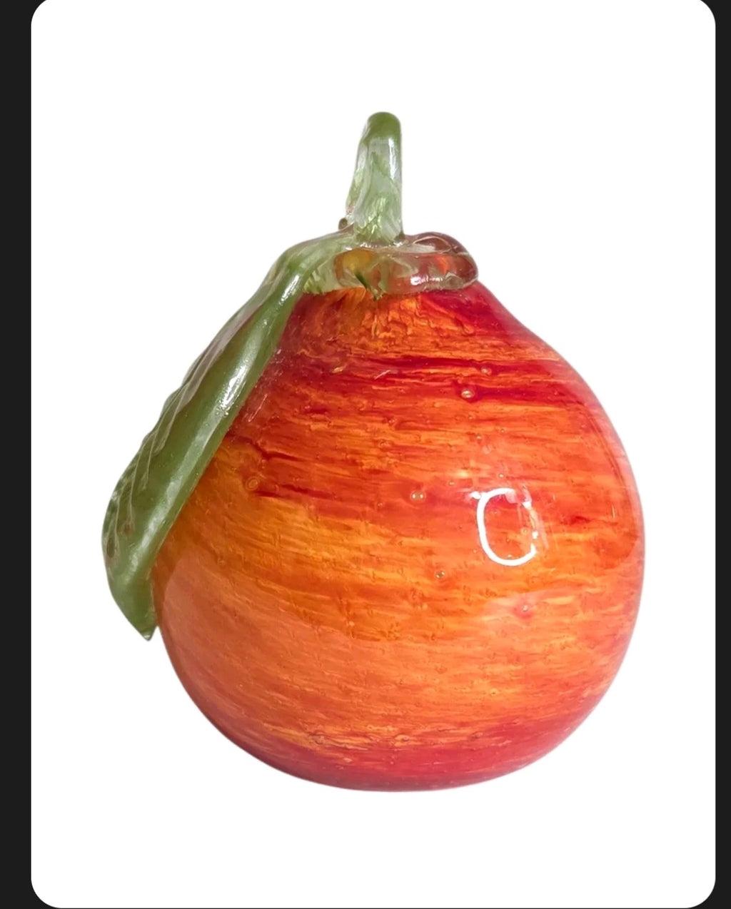 Oddly Darling Vintage hand blown glass fruit paperweight in sunset orange and red with a green glass leaf detail.