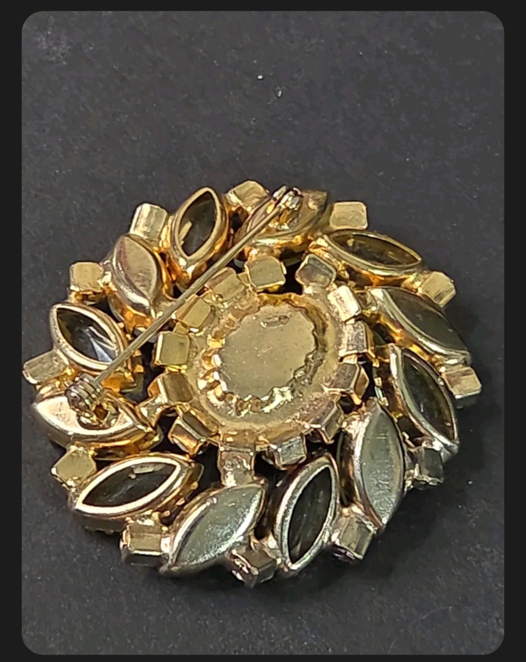Back view of an Oddly Darling Vintage gold-tone floral brooch featuring a secure pin-back closure and marquise stones.