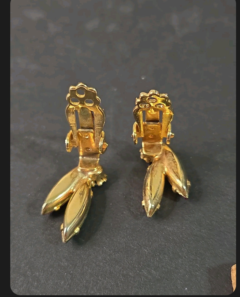 Oddly Darling Vintage gold-tone clip-on earrings showing the sturdy back mechanism and leaf-shaped crystal settings.