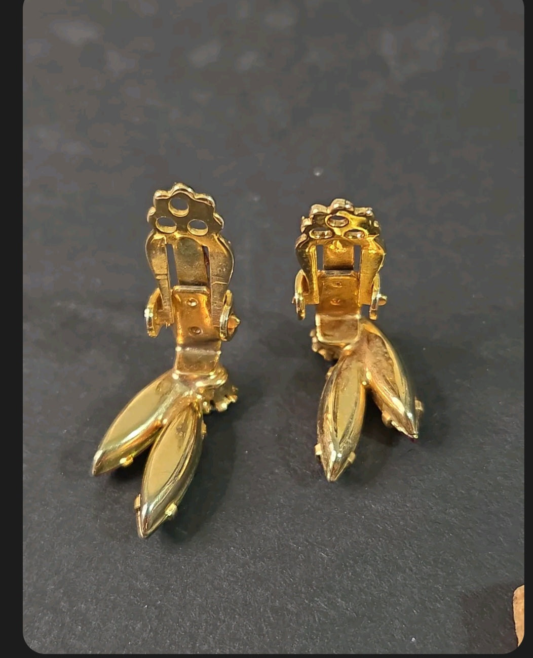 Oddly Darling Vintage gold-tone clip-on earrings showing the sturdy back mechanism and leaf-shaped crystal settings.