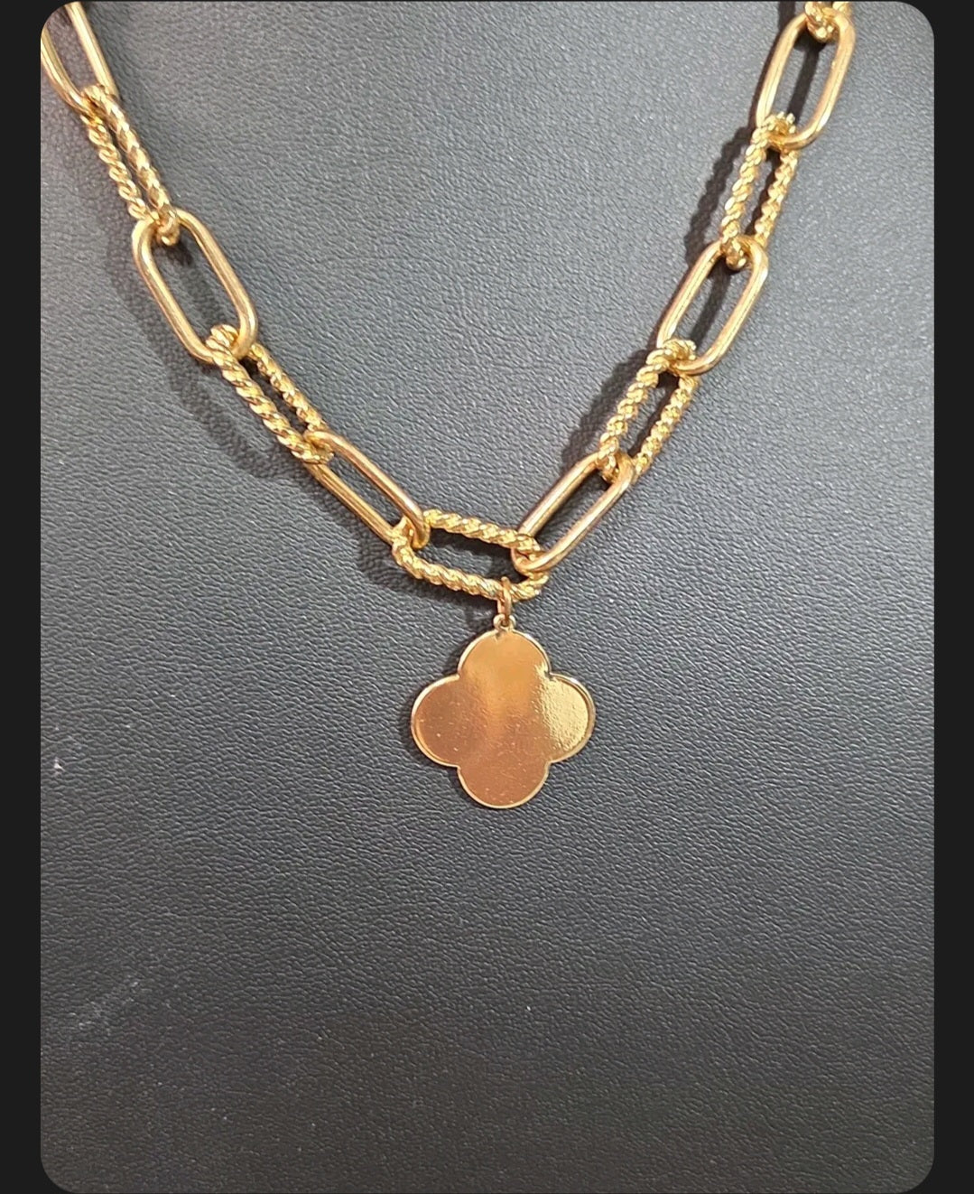 Oddly Darling Vintage gold-tone clover charm necklace featuring a textured mixed-link chain with rope and oval links.