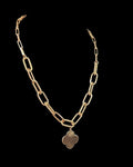 Oddly Darling Vintage gold-tone necklace featuring a polished clover charm on a textured mixed-link chain.