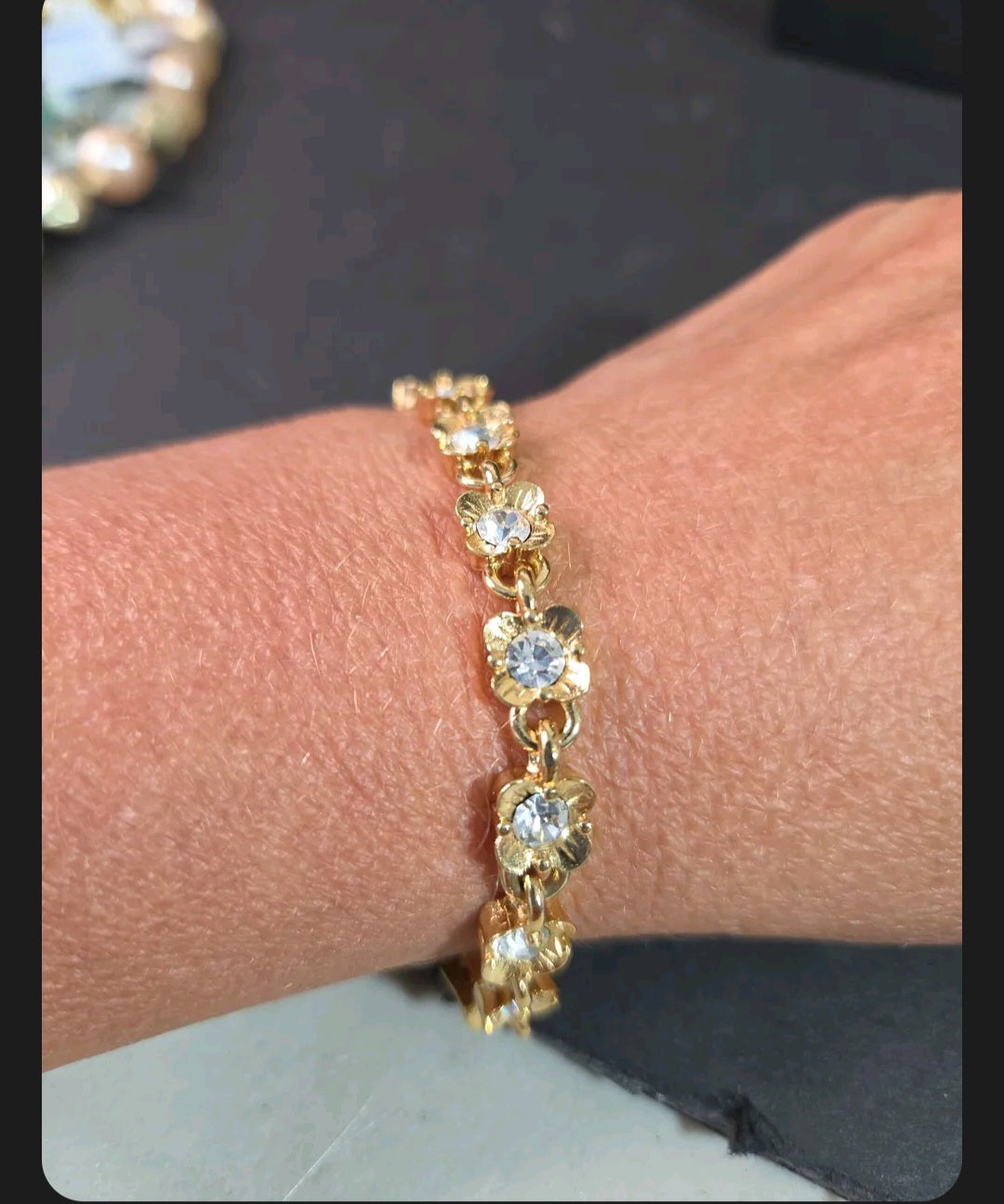 Oddly Darling Vintage gold-tone floral link bracelet featuring sparkling clear crystals worn on a wrist