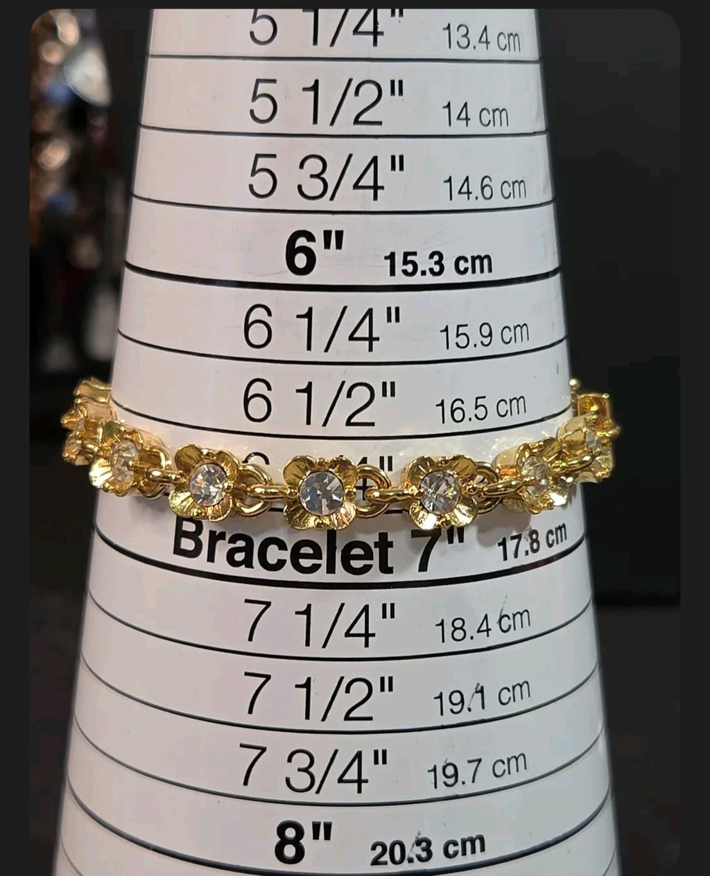 Oddly Darling Vintage gold-tone floral link bracelet with clear crystal centers displayed on a sizing mandrel