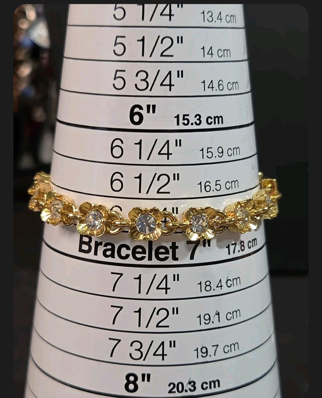 Oddly Darling Vintage gold-tone floral link bracelet with clear crystal centers displayed on a sizing mandrel