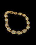 Oddly Darling Vintage gold-tone floral link bracelet featuring sparkling clear crystal centers and a fold-over clasp.